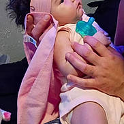 Bella is registered to the contest to win money with this photo: baby, blanket, child, clothing, cozy, curious, cute, fabric, face, hand, holding, indoors, infant, pacifier, person, pink_headband, portrait, skin, soft_lighting, toddler