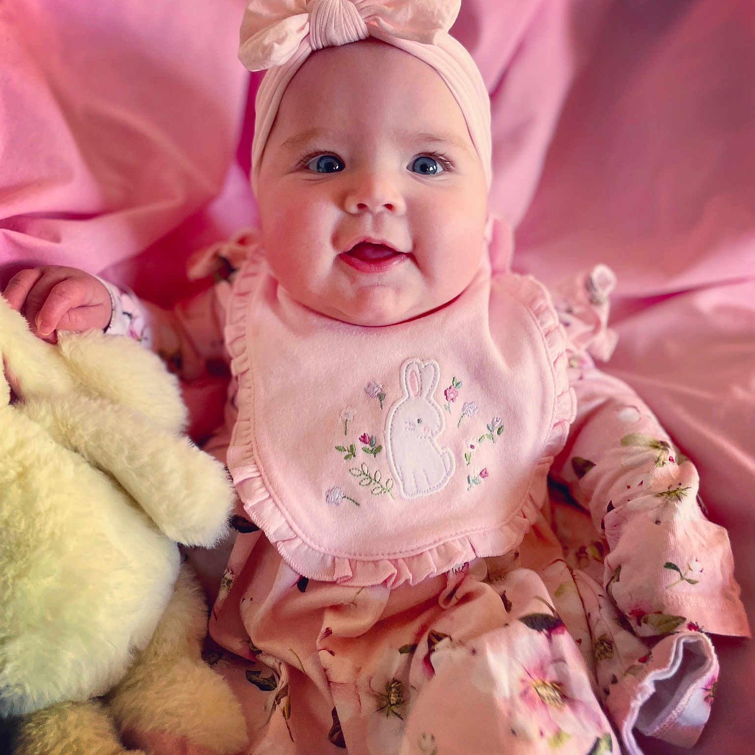 Kady-May joined the competition — help win amazing prizes! baby, bodypart, bonnet, cap, clothing, couch, dress, face, finger, hand, happy, hat, head, newborn, person, photography, portrait, sitting, smile, toy