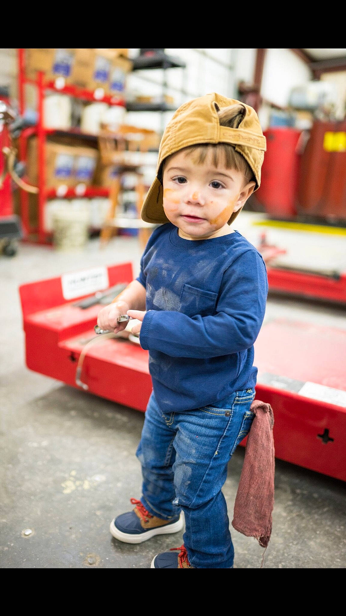 Tripp is registered to the contest to win money with this photo: baby, baseball_cap, child, child_model, denim, electric_blue, footwear, headgear, headwear, jeans, male, outerwear, person, play, shoe, sleeve, snapshot, standing, toddler