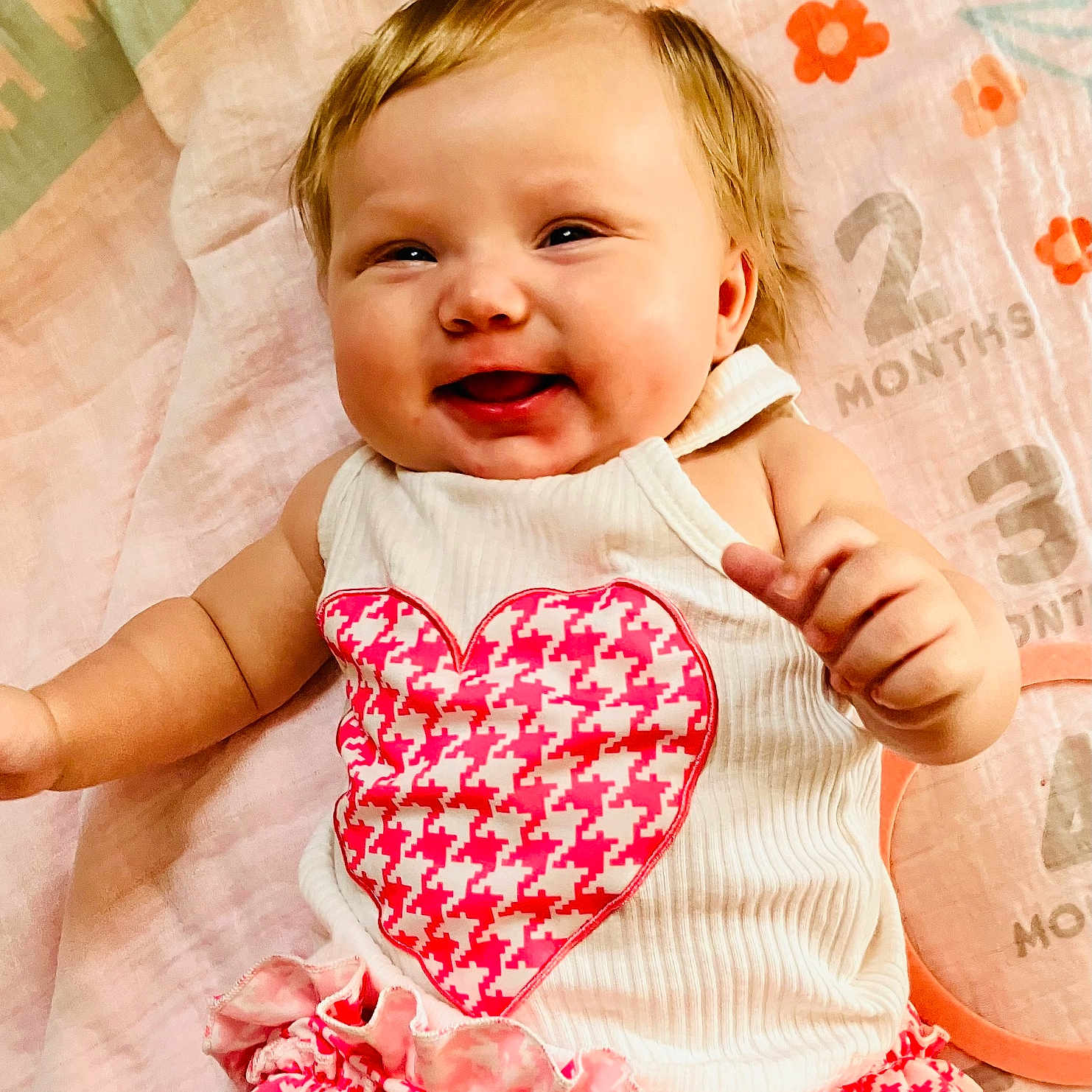 Caylee joined the competition — help win amazing prizes! applique, baby, babylaughing, bodypart, clothing, dress, face, finger, hand, happy, head, laughing, pattern, person, photography, portrait, sitting, smile, symbol, t_shirt