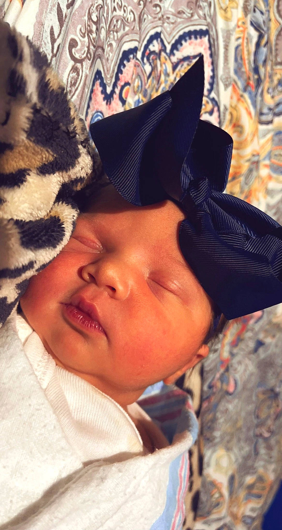 Mckinlee is registered to the contest to win money with this photo: black_hair, cap, child, close_up, cool, eyebrow, eyelash, facial_expression, gesture, happy, hat, headgear, headwear, linens, lip, neck, nose, pattern, person, skin
