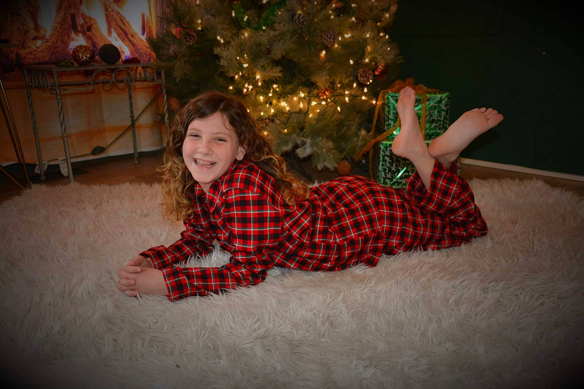 Riley is registered to the contest to win money with this photo: christmas, christmas_decoration, christmas_ornament, christmas_tree, comfort, event, facial_expression, flash_photography, fun, happy, holiday, human_body, joy, lap, leg, mammal, ornament, person, plant, smile