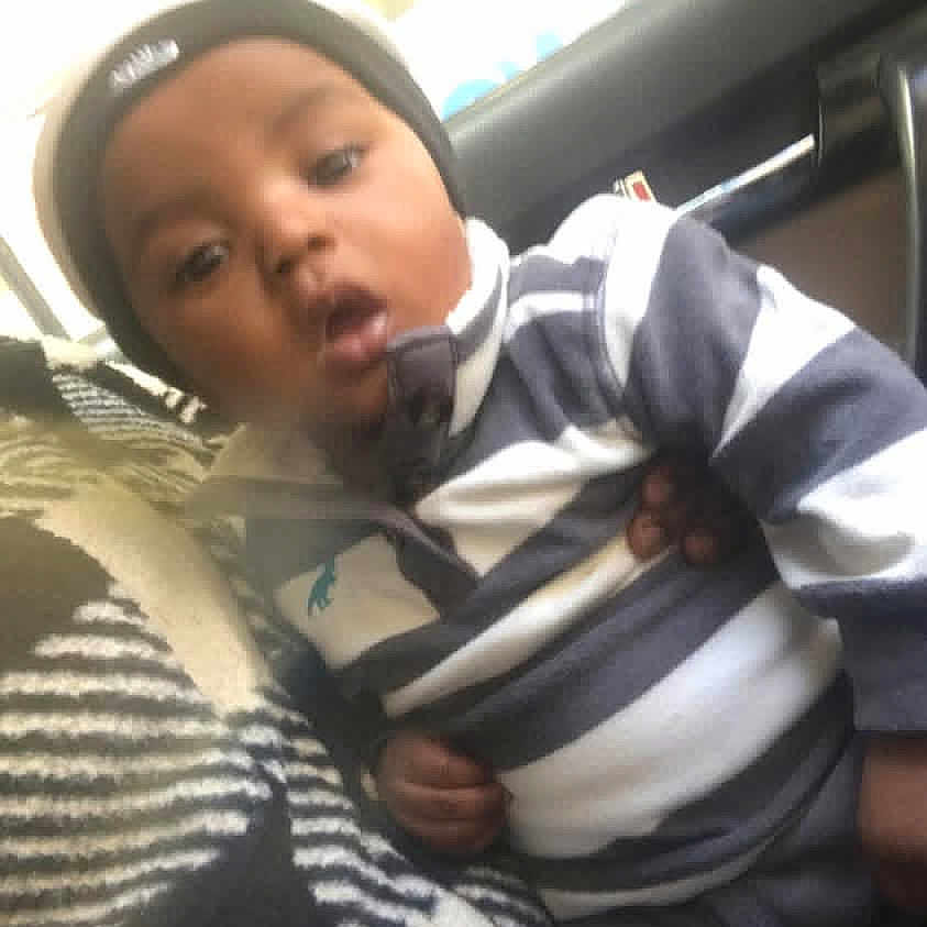 Cruz joined the competition — help win amazing prizes! child, baby, striped_clothing, beanie, sitting, vehicle, window, person, indoor, lap, curious, casual, portrait, young, clothing, seat, hand, headwear, face, cozy