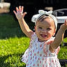Amari joined the competition — help win amazing prizes! child, toddler, smiling, happy, arms_up, headband, dress, outdoor, grass, sunlight, stroller, vehicle, baby, cute, portrait, sitting, daylight, playful, person, nature