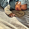 Amari is registered to the contest to win money with this photo: baby, infant, smiling, blue_bow, headband, wooden_plaque, four_months, blanket, laying_down, milestone, cute, happy, child, portrait, indoor, soft_texture, clothing, earrings, closeup, person
