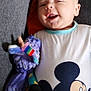 Livio a rejoint le concours — aidez-le/la à gagner de superbes lots ! baby, infant, smiling, plush_toy, unicorn, couch, pillow, clothing, mickey_mouse, cute, happy, indoors, child, person, portrait, sitting, toy, comfortable, colorful, baby_clothes