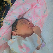 Tasneem is registered to the contest to win money with this photo: baby, baby_clothing, blanket, child, closed_eyes, cozy, floral_pattern, hand, indoors, infant, lying_down, nursery, onesie, peaceful, pink, plush_blanket, portrait, sleeping, soft_lighting, white