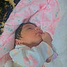 baby, baby_clothing, blanket, child, closed_eyes, cozy, floral_pattern, hand, indoors, infant, lying_down, nursery, onesie, peaceful, pink, plush_blanket, portrait, sleeping, soft_lighting, white
