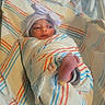 Tasneem is registered to the contest to win money with this photo: baby, blanket, bow, child, cute, eyes, face, foot, headband, hospital, indoor, infant, lying_down, medical, newborn, newborn_photography, portrait, sleeping, striped_blanket, swaddled