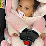 adorable, baby, big_eyes, blanket, buckle, car_seat, close_up, cozy, curly_hair, fingers, hood, infant, jacket, pacifier, pink, portrait, safety_belt, seat_padding, soft_texture, strap