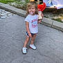 blankets, child, concrete, cute, daylight, grass, milk_bottle, outdoor, pacifier, person, picnic_table, playtime, shorts, sneakers, standing, summer, toddler, towels, trees, white_tshirt