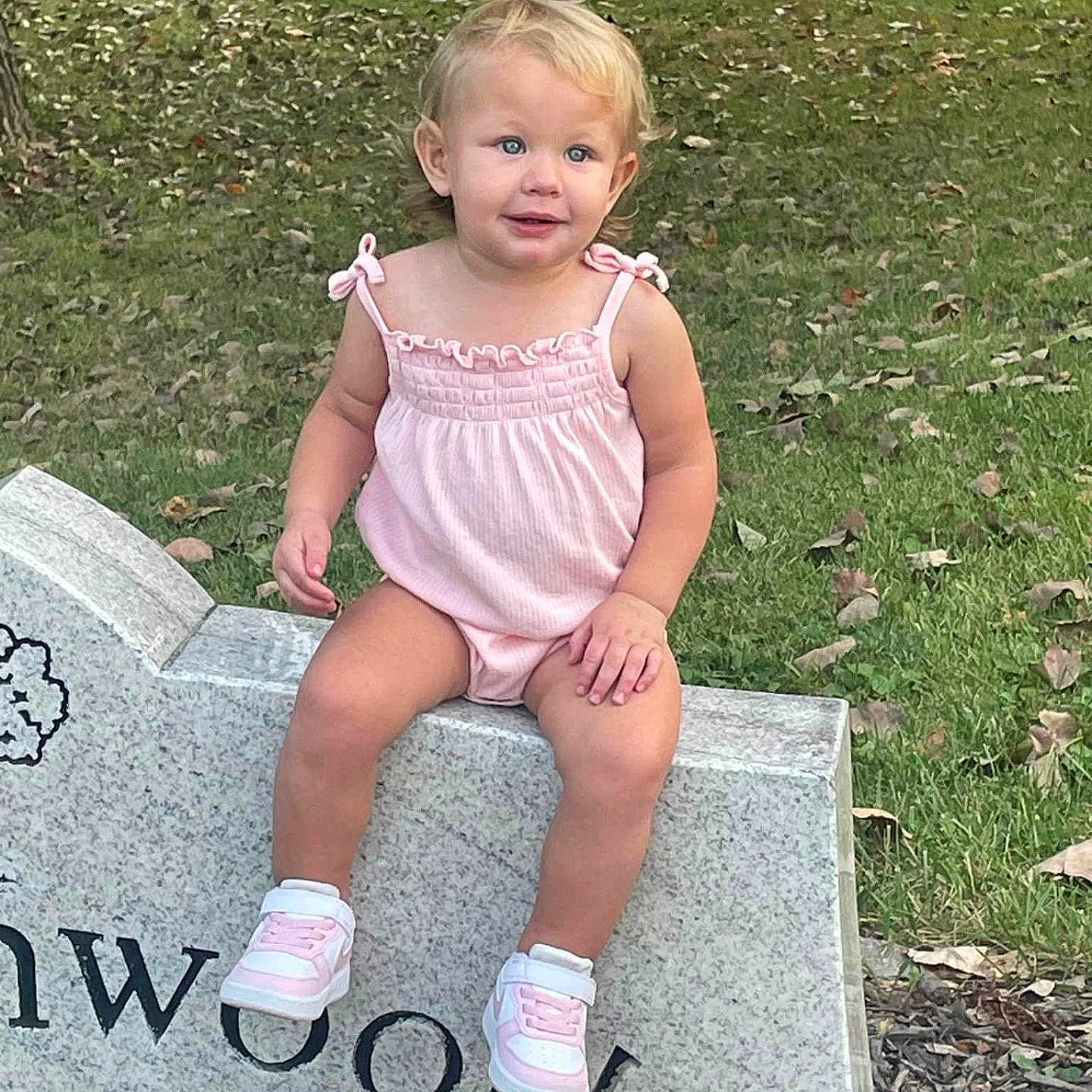 Londyn is registered to the contest to win money with this photo: blonde, child, clothing, dress, face, female, footwear, girl, grass, gravestone, hair, head, person, photography, plant, portrait, shoe, sitting, standing, tomb