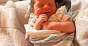 Brooklyn is registered to the contest to win money with this photo: baby, blanket, closeup, comfort, cozy, cute, fabric, hand, indoor, infant, newborn, person, portrait, rest, skin, sleeping, smile, soft_light, swaddle, warmth
