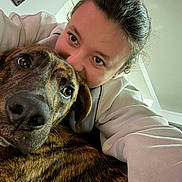 Cookie participe au concours pour gagner de l'argent avec cette photo : animal, brindle, brown, casual, close_up, companion, cuddle, dog, eyes, face, friendship, fur, happy, indoor, nose, person, pet, selfie, smile, sweatshirt