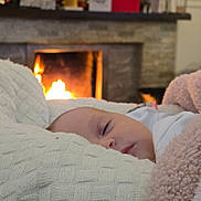 Rosie joined the competition — help win amazing prizes! baby, blanket, fireplace, sleeping, cozy, indoor, knitted, soft, warm, child, infant, face, resting, comfort, home, couch, relaxation, furniture, portrait, blanket_texture