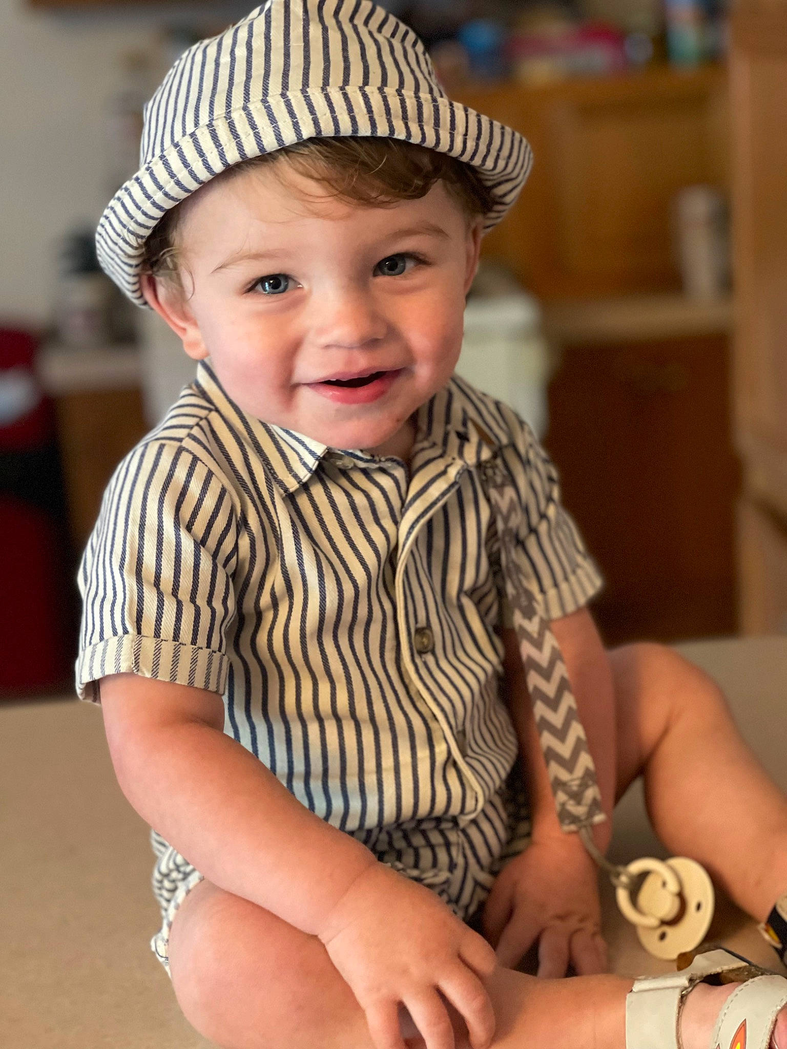 Colton is registered to the contest to win money with this photo: baby_toddler_clothing, cap, child, costume_hat, eye, face, fedora, fun, happy, hat, headgear, headwear, joy, person, photograph, skin, sleeve, smile, sun_hat, thumb