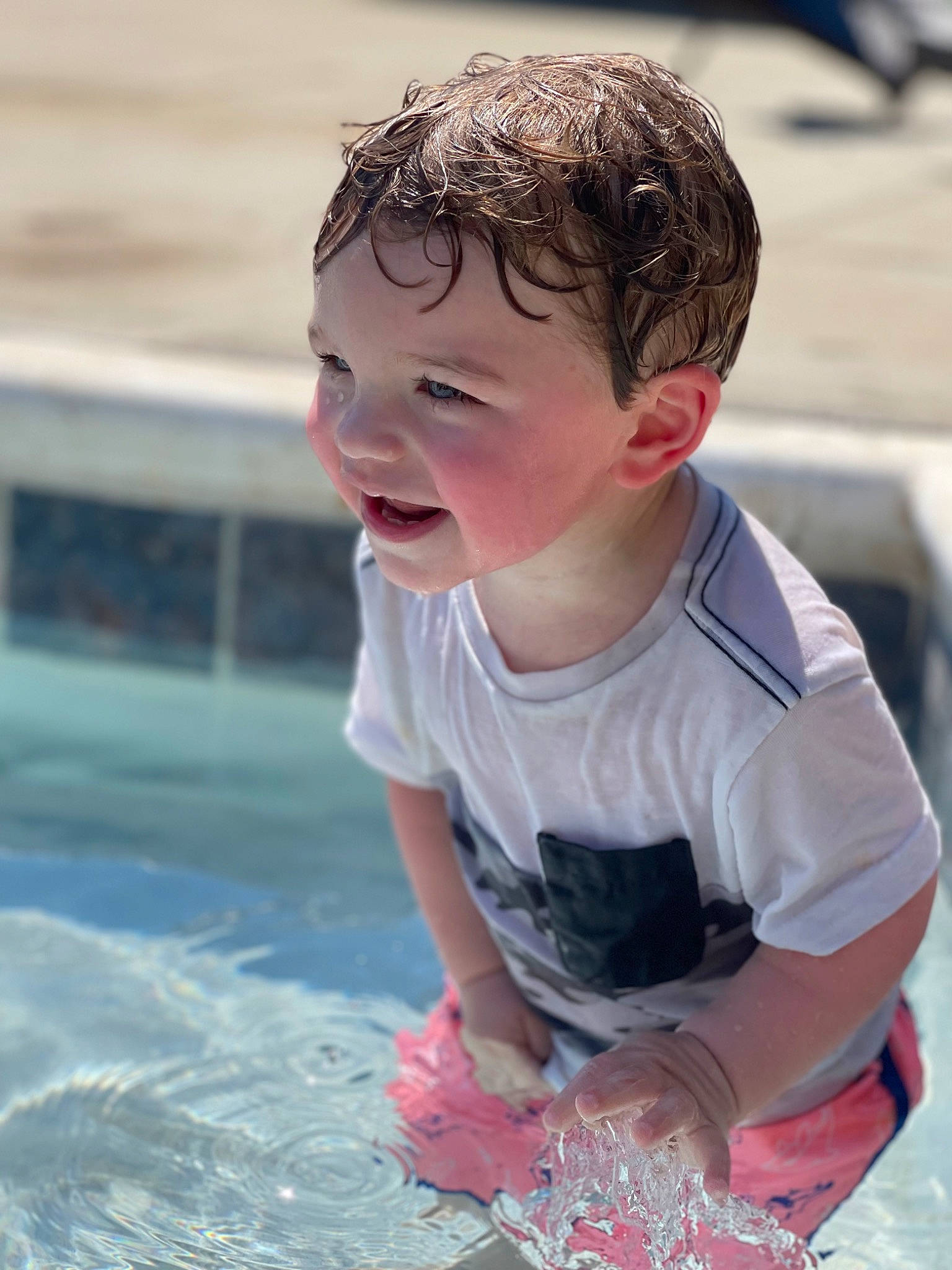 Colton is registered to the contest to win money with this photo: baby_toddler_clothing, child, fun, grass, happy, laugh, leisure, person, personal_protective_equipment, play, recreation, sand, sitting, skin, smile, summer, swimming_pool, t_shirt, toddler, vacation