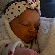Joy participe au concours pour gagner de l'argent avec cette photo : baby, sleeping, headband, hearts, hand, knitwear, white, cozy, infant, peaceful, closeup, soft, cute, child, portrait, resting, warmth, indoors, person, newborn