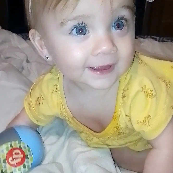 Nellie is registered to the contest to win money with this photo: accessories, baby, bed, bedroom, clothing, crawling, cushion, face, furniture, happy, head, homedecor, indoors, person, photography, portrait, room, smile, t_shirt, tape