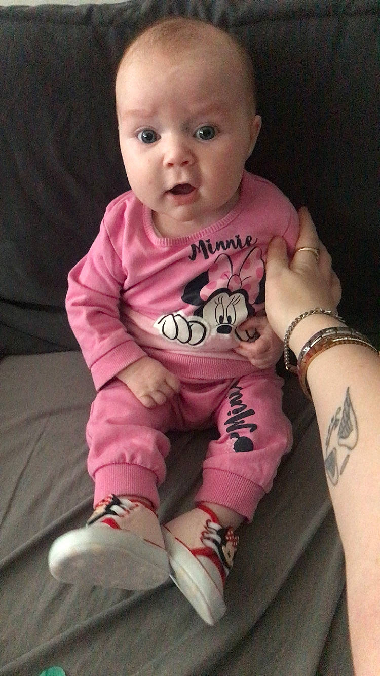 Mckenzie joined the competition — help win amazing prizes! accessories, baby, bodypart, bracelet, clothing, couch, face, finger, footwear, furniture, head, jewelry, pants, person, photography, portrait, shoe, sitting, skin, tattoo