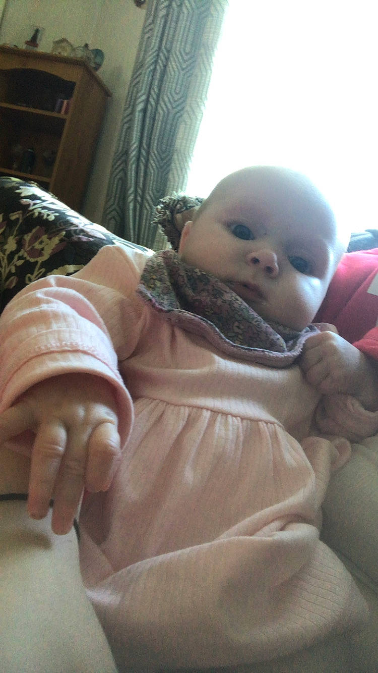 architecture, baby, bodypart, building, clothing, coat, couch, cushion, face, finger, furniture, hand, head, homedecor, indoors, jacket, livingroom, person, photography, portrait