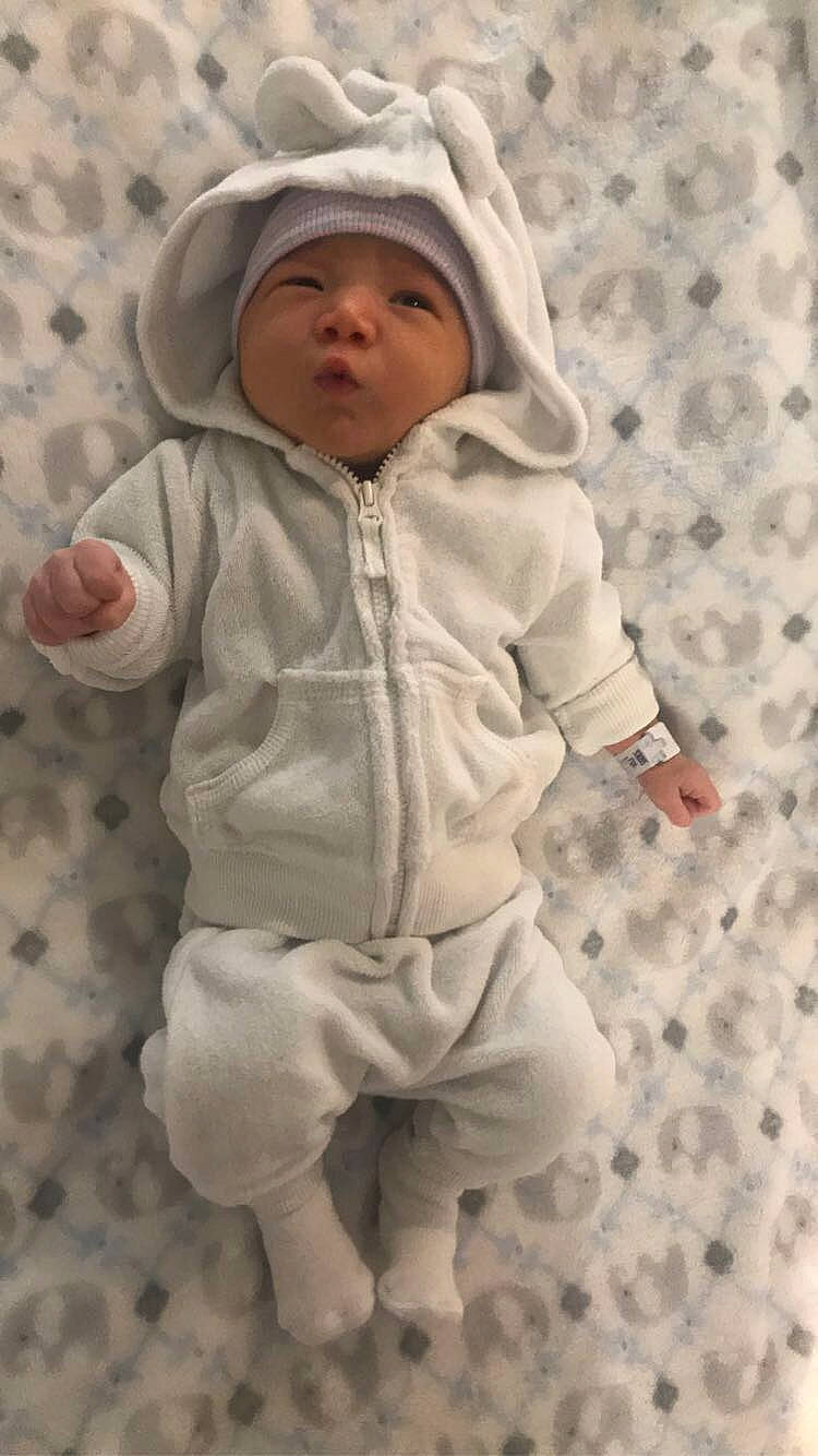 Gilbert is registered to the contest to win money with this photo: baby, child, headwear, hood, hoodie, outerwear, person, toddler