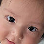 baby, close_up, face, eyes, skin, cheeks, expression, curious, infant, person, portrait, cute, child, newborn, adorable, soft, gentle, hand, fingers, white_clothing
