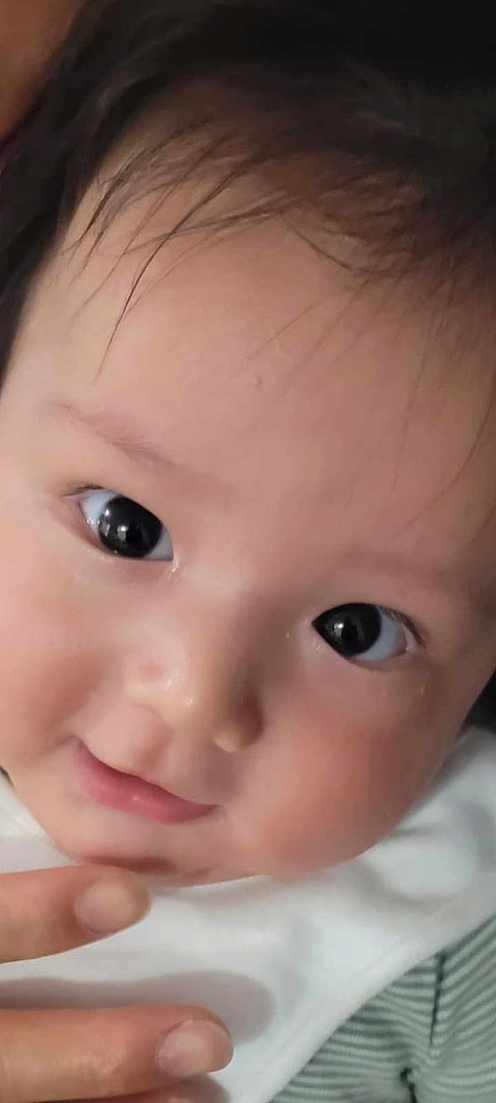 Isaac joined the competition — help win amazing prizes! baby, close_up, face, eyes, skin, cheeks, expression, curious, infant, person, portrait, cute, child, newborn, adorable, soft, gentle, hand, fingers, white_clothing