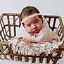 Sara is registered to the contest to win money with this photo: baby, infant, blanket, wooden_basket, headband, lace, soft_texture, cute, wrapped, portrait, indoors, newborn, child, adorable, cozy, hands, face, expression, resting, pink