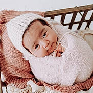 Sara is registered to the contest to win money with this photo: baby, infant, knitwear, pink, blanket, basket, cozy, cute, portrait, child, sleepy, soft, warm, indoors, newborn, wrapped, headwear, texture, resting, toddler