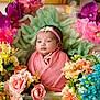 baby, infant, flower_arrangement, pink_blanket, headband, portrait, closeup, colorful_flowers, green_backdrop, soft_texture, cute, newborn, wrapped, floral, decorative, peaceful, indoors, child, baby_face, still_life