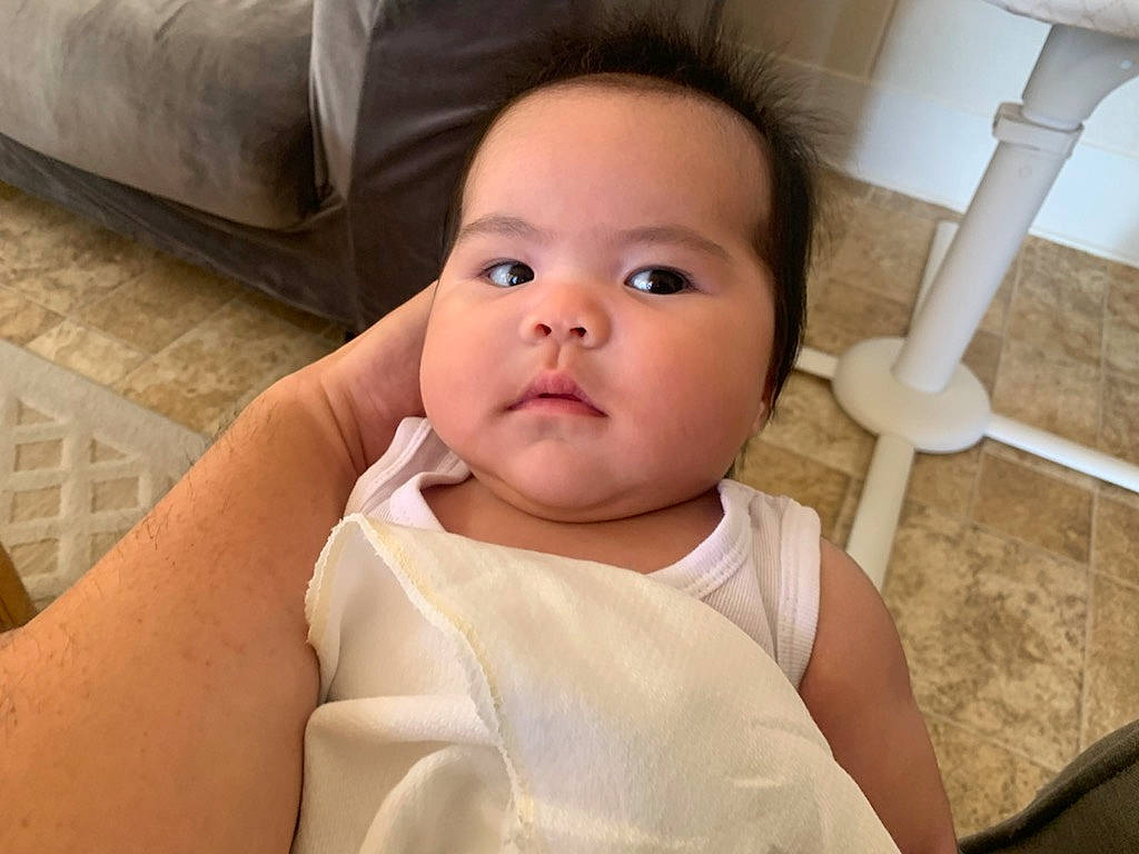 Jeannie is registered to the contest to win money with this photo: baby, baby_toddler_clothing, cheek, chest, chin, comfort, eye, eyebrow, eyelash, gesture, happy, head, iris, lip, mouth, neck, nose, person, skin, smile