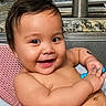 baby, smiling, sink, bath, water_droplets, toy, happy, child, kitchen, pink_bath_mat, face, skin, arm, hand, faucet, countertop, liquid_wash_bottle, indoor, person, cute