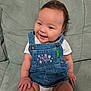 Mariana joined the competition — help win amazing prizes! baby, infant, denim_overall, smiling, sitting, couch, green_couch, cute, indoor, child, happy, face, clothing, cute_outfit, shorts, white_shirt, plush, skin, person, portrait