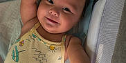 Mariana is registered to the contest to win money with this photo: baby, smiling, infant, onesie, arm, face, bed, bedding, crib, mesh, light, happy, child, person, cute, sleeping_area, toddler, soft, indoors, skin