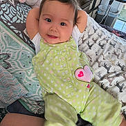 Mariana joined the competition — help win amazing prizes! baby, infant, smile, happy, lying_down, bed, blanket, pillow, polka_dot, green_outfit, heart_patch, plush_toy, monitor, nursery, cute, big_eyes, rosy_cheeks, arms_up, legs_motion_blur, portrait