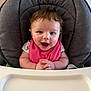baby, high_chair, pink_bib, smiling, happy, child, indoor, face, cute, infant, clothing, person, seat, feeding_chair, table, baby_girl, portrait, hands, hair, eyes