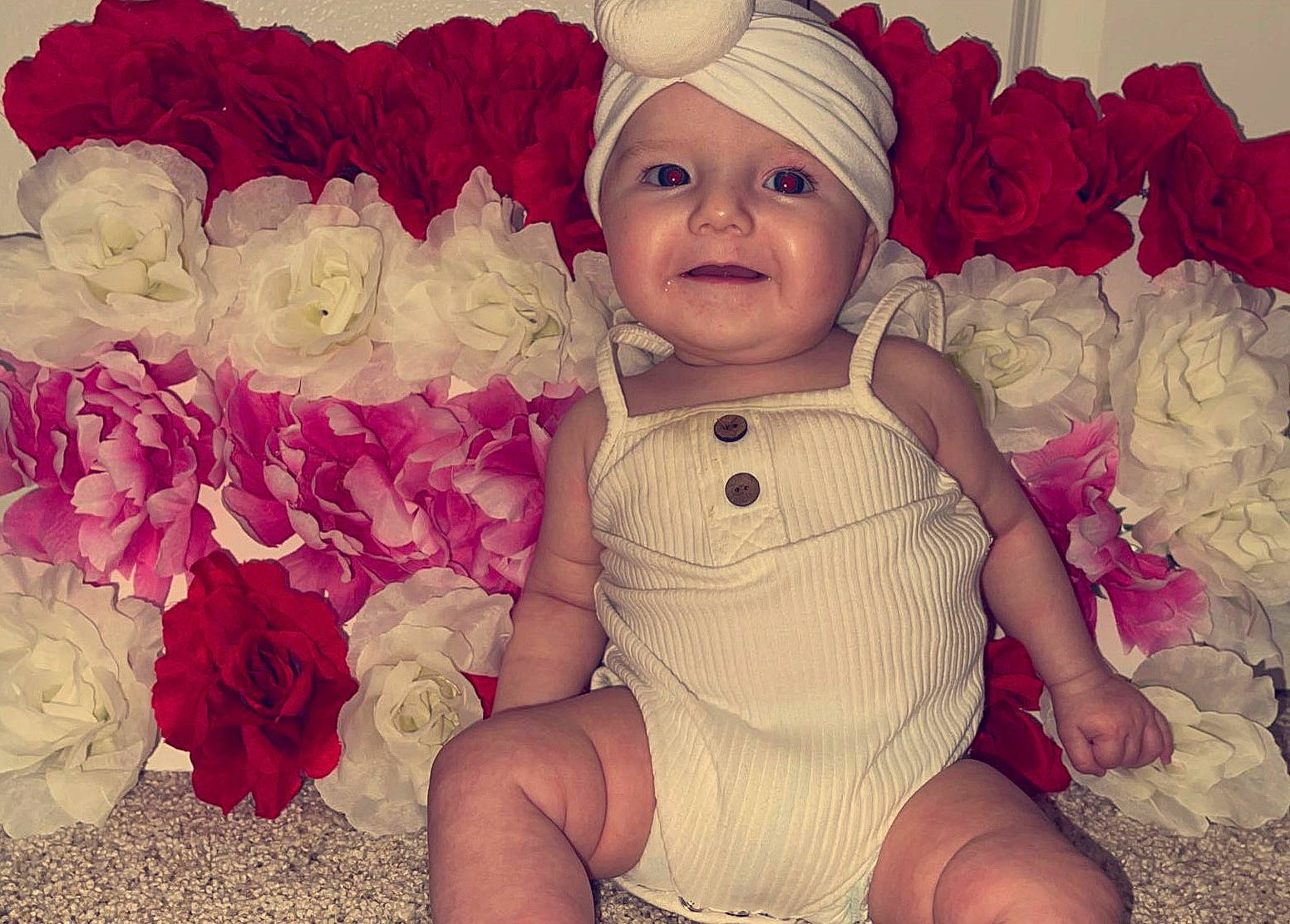 Kinley joined the competition — help win amazing prizes! baby, baby_toddler_clothing, child, cut_flowers, flower, flower_arranging, happy, hat, headgear, headwear, magenta, pattern, peach, person, petal, pink, purple, smile, textile, thigh