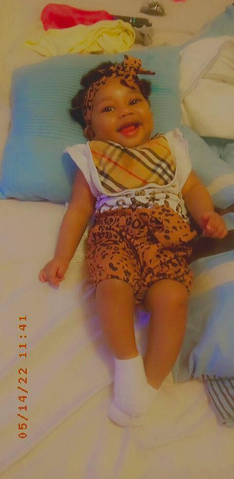 Khourtney is registered to the contest to win money with this photo: abdomen, baby_toddler_clothing, cheek, child, comfort, eye, face, head, headwear, human_leg, joint, knee, leg, pattern, person, skin, sleeve, thigh, thumb, toddler