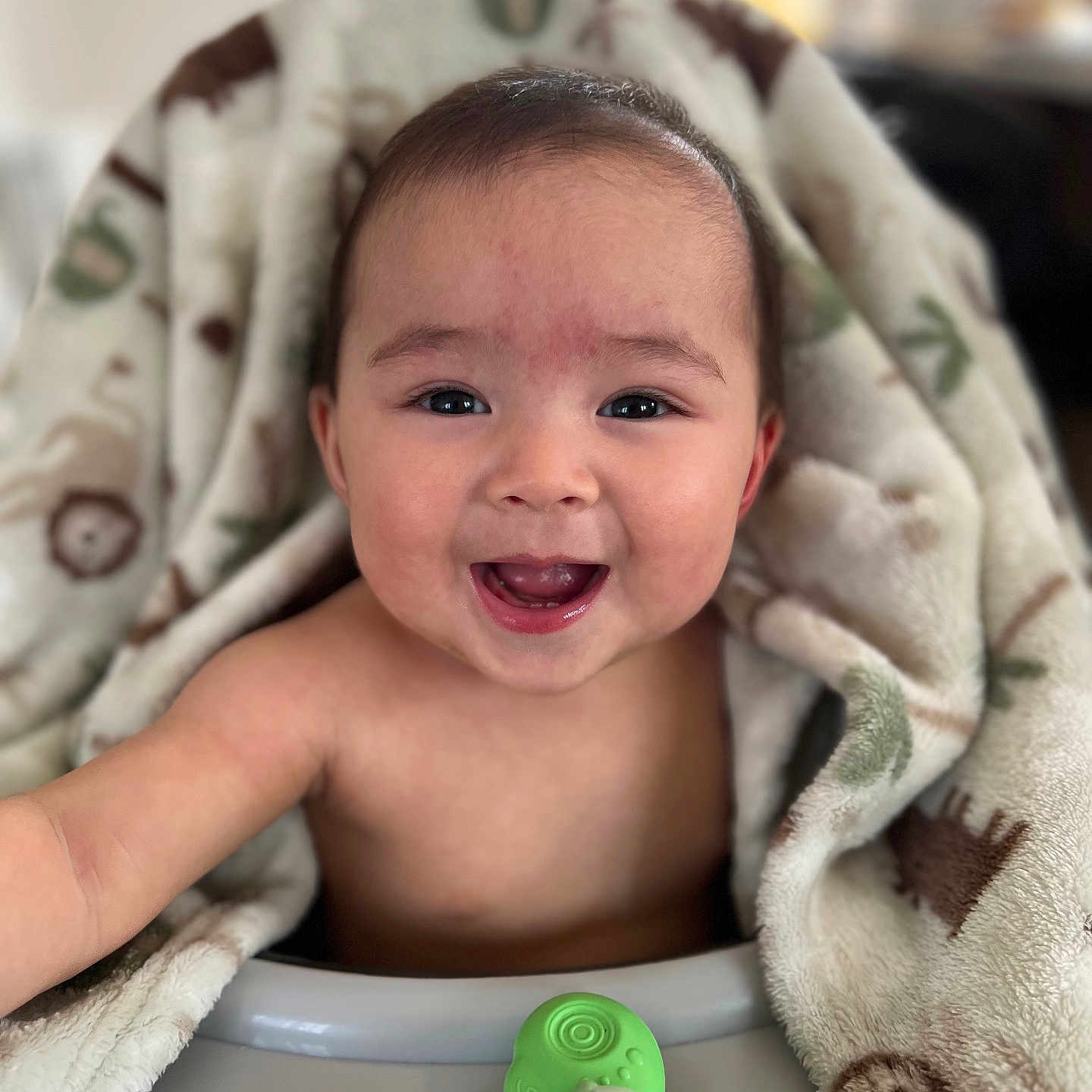 Keana joined the competition — help win amazing prizes! baby, blanket, child, closeup, comfort, cute, expression, face, furniture, green, happy, high_chair, indoor, infant, person, playful, skin, smiling, toy, warm