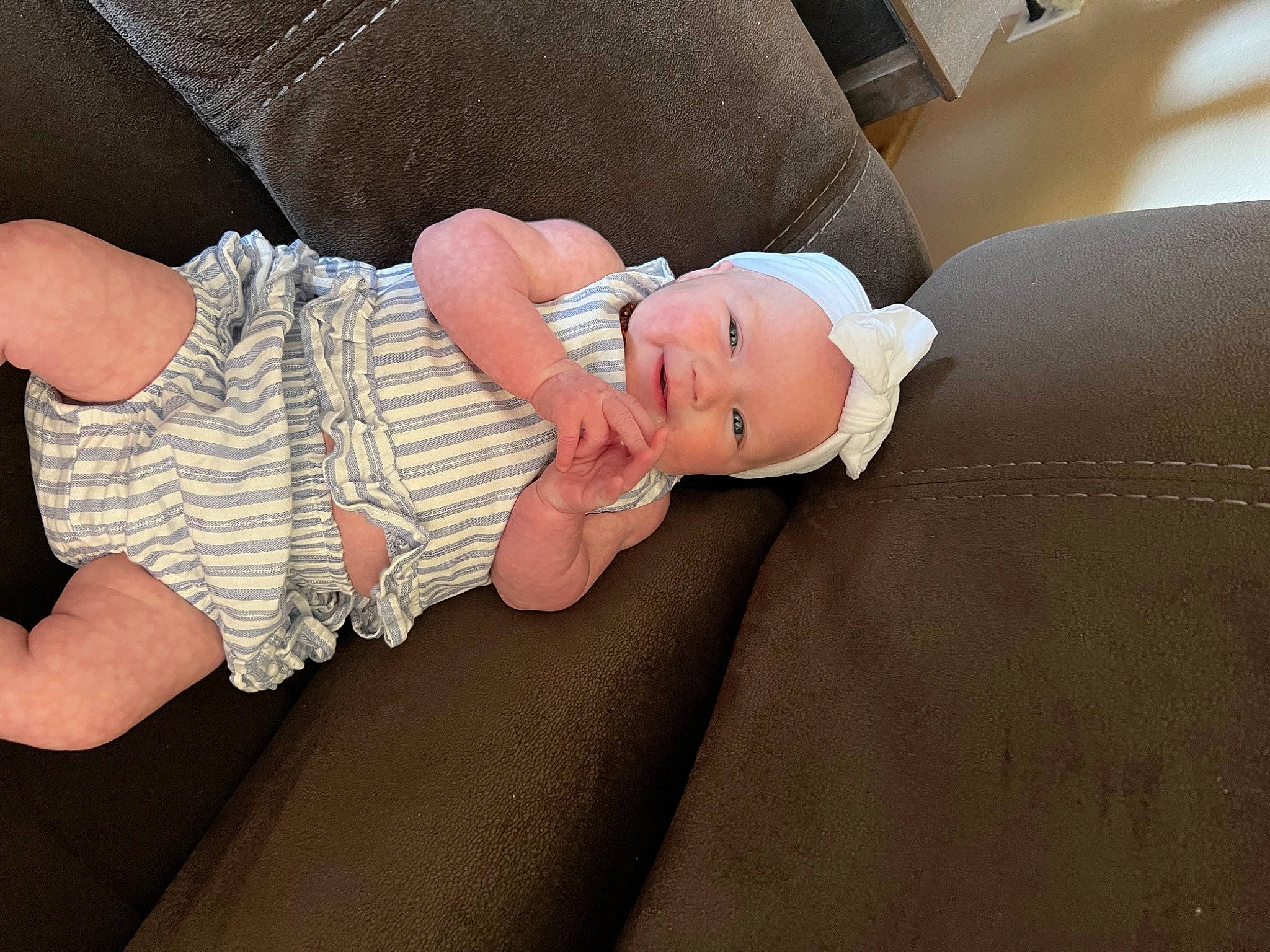 Jayde joined the competition — help win amazing prizes! baby, baby_products, baby_toddler_clothing, child, comfort, finger, foot, gesture, glasses, headwear, human_body, human_leg, linens, nail, person, sitting, skin, sleeve, thigh, thumb