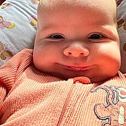 Charlotte joined the competition — help win amazing prizes! baby, smiling, face, infant, cheeks, orange_clothing, tiger_patch, pillow, butterfly_pattern, blanket, soft_lighting, closeup, cute, indoors, child, young, portrait, sleepwear, happy, cozy