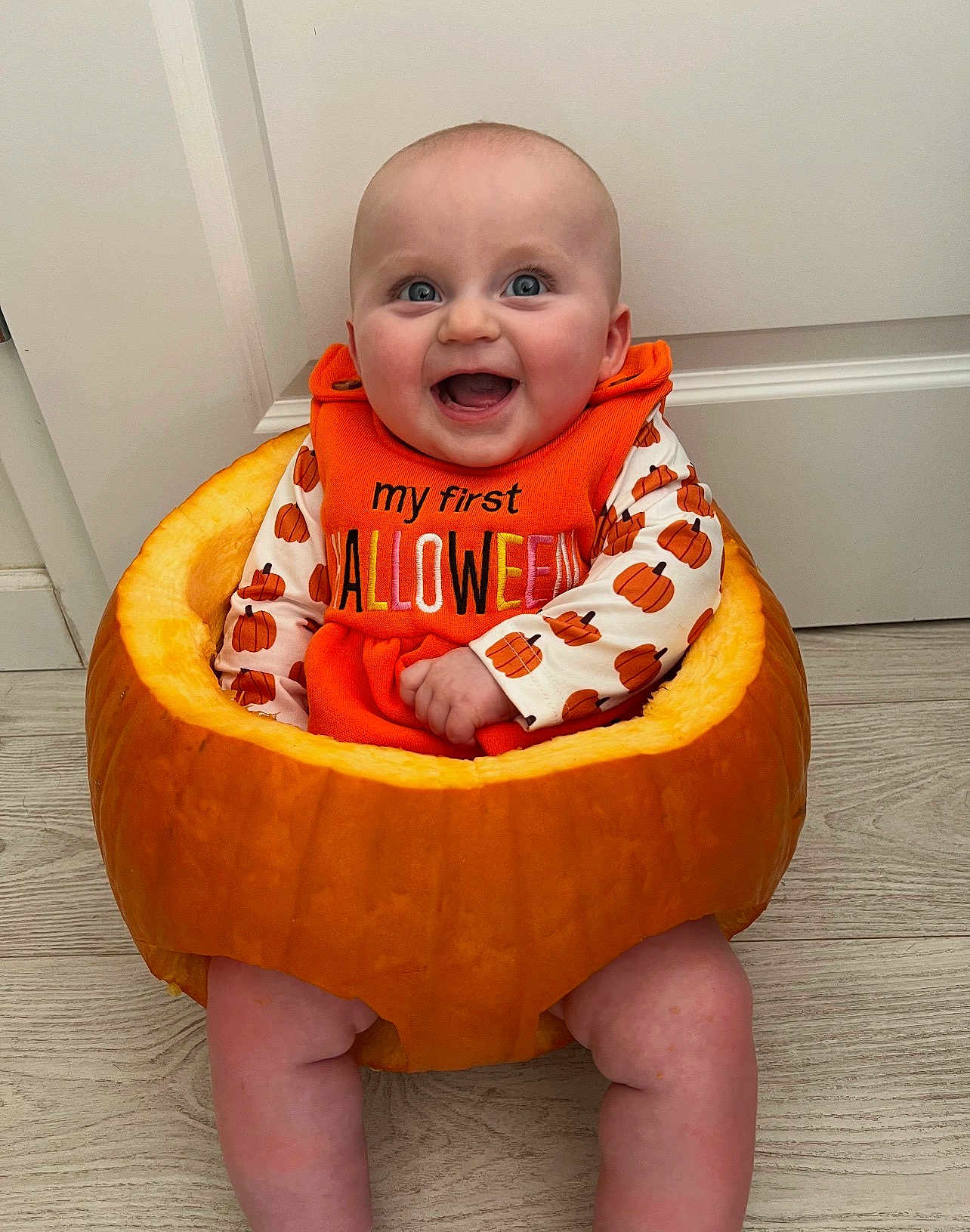Niamh is registered to the contest to win money with this photo: baby, pumpkin, halloween, orange, smile, child, holiday, costume, festive, cute, indoors, floor, door, celebration, happy, sitting, person, head, face, clothing