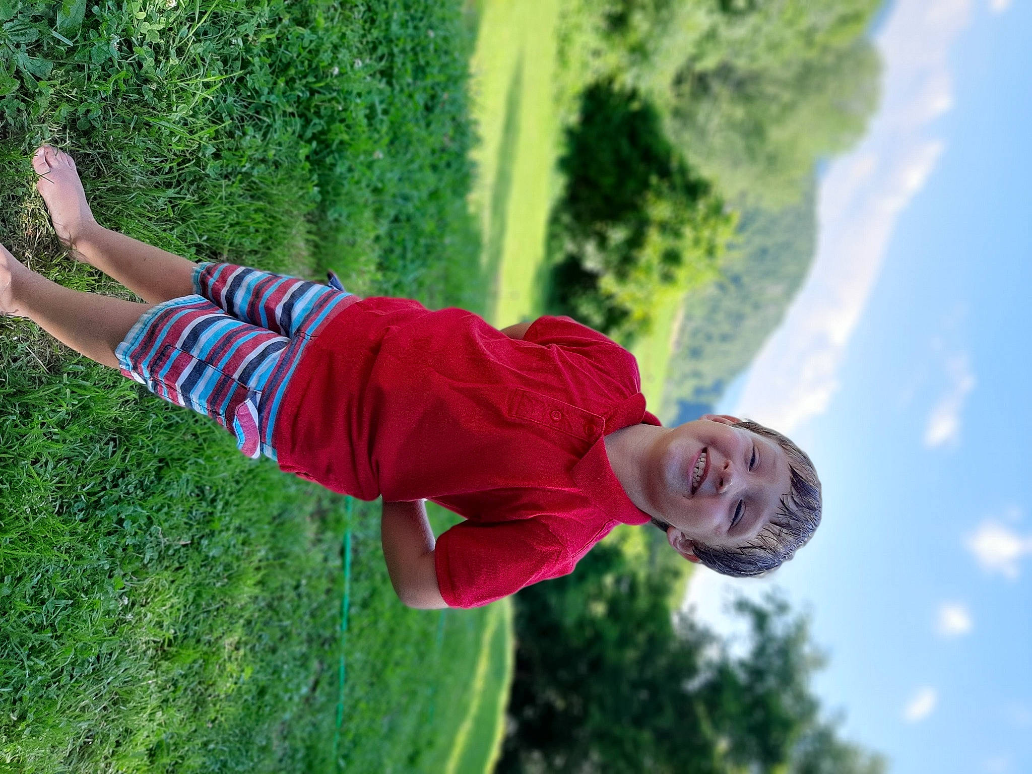 Trenton is registered to the contest to win money with this photo: child, fun, grass, green, happy, joy, leisure, people_in_nature, person, photography, plant, tree, vacation