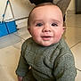 Naëlyo a rejoint le concours — aidez-le/la à gagner de superbes lots ! baby, toddler, infant, green_sweater, sitting, tile_floor, indoors, smile, cheeks, blue_bucket, eyes, portrait, closeup, hand, button, curly_hair, knees, curious_expression, floor_tile, home