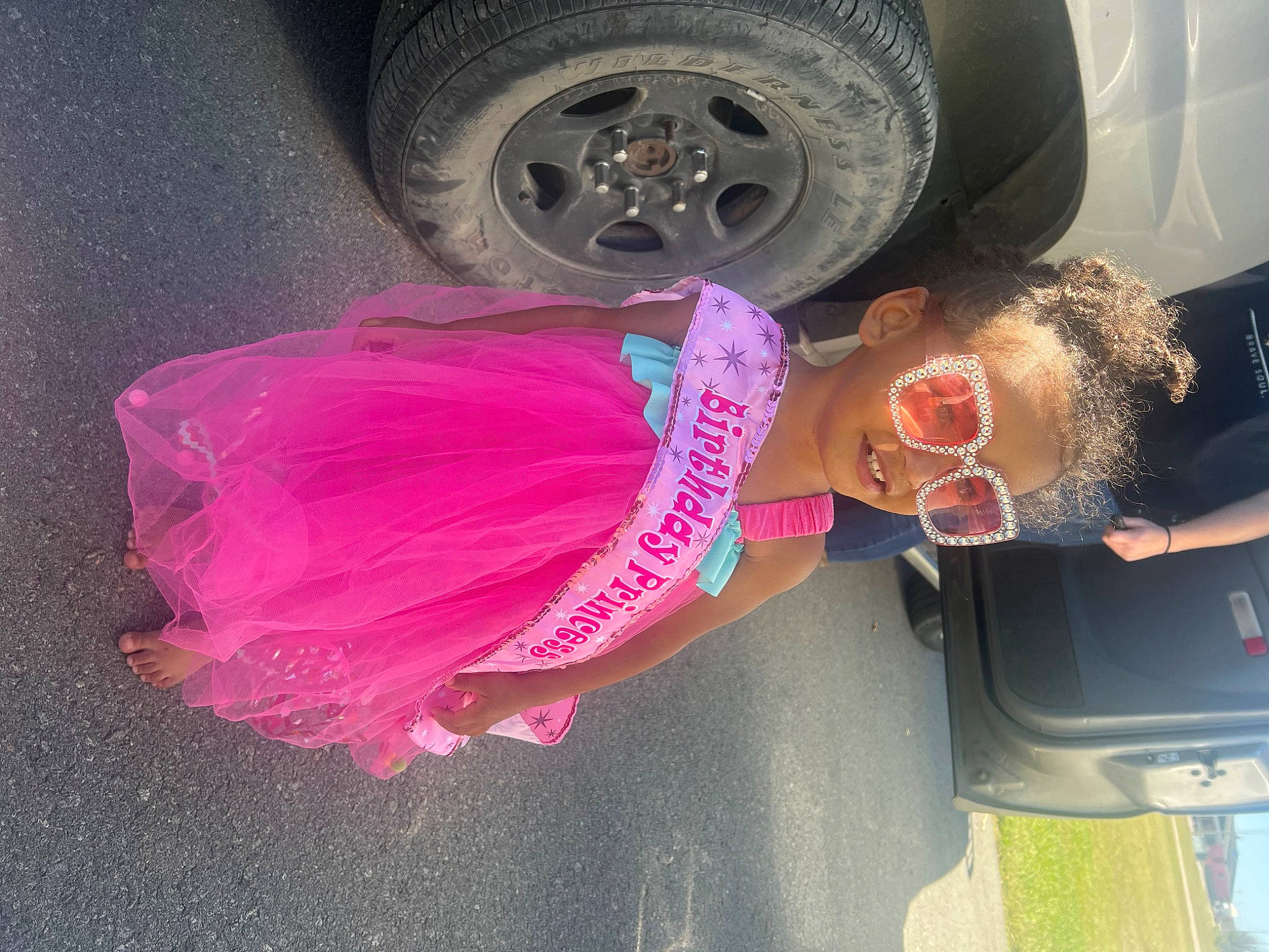 Armoni is registered to the contest to win money with this photo: automotive_design, automotive_exterior, automotive_lighting, automotive_tire, bumper, car, fender, hood, hubcap, motor_vehicle, person, pink, rim, smile, synthetic_rubber, tire, tread, trunk, vehicle, vehicle_door