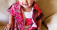 Alessio joined the competition — help win amazing prizes! child, toddler, sitting, sofa, portrait, smiling, tongue_out, patterned_shirt, red_clothing, white_shirt, barefoot, indoors, couch, furniture, leather, happy, face, short_hair, casual, family_photo