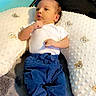 Alessio joined the competition — help win amazing prizes! baby, child, infant, portrait, lying_down, awake, white_shirt, blue_pants, yellow_shoes, sneakers, pillows, blanket, cozy, indoor, nursery, furniture, wall_decor, curly_design, baby_clothing, full_body