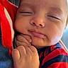 Alessio joined the competition — help win amazing prizes! newborn, baby, infant, sleeping, sleepy, face, portrait, close_up, smiling, hands, fist, striped_clothing, red, navy_blue, onesie, cuddling, adult, indoor, cozy, photography