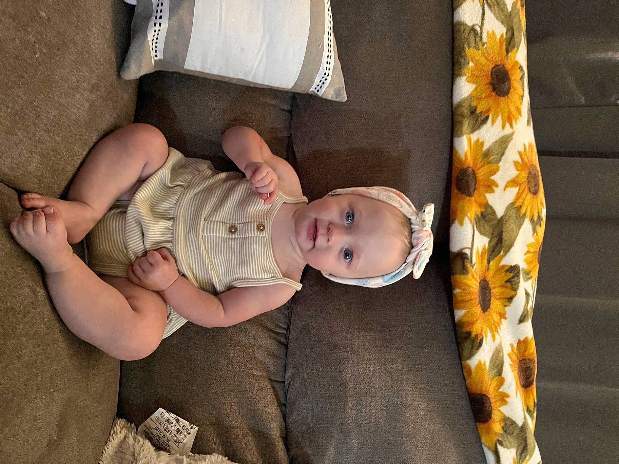 Ayden is registered to the contest to win money with this photo: baby, baby_products, baby_toddler_clothing, book, child, comfort, eye, foot, glasses, hat, headgear, human_body, human_leg, pattern, person, room, sitting, skin, thigh, toddler